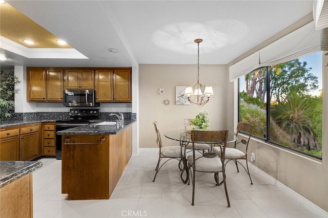 1610 Via Estrella, Pomona, CA 91768 - kitchen featuring brown cabinetry, black range with electric cooktop, a raised ceiling, dark stone counters, and stainless steel microwave