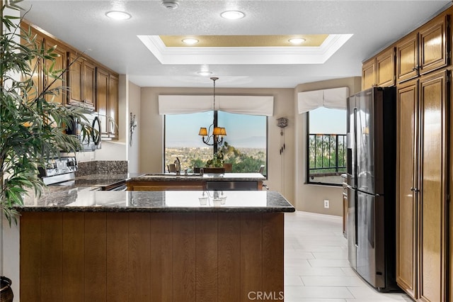 1610 Via Estrella, Pomona, CA 91768 - kitchen featuring a raised ceiling, a peninsula, ornamental molding, stainless steel appliances, and plenty of natural light