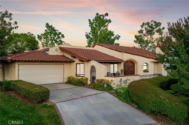 1610 Via Estrella, Pomona, CA 91768 - mediterranean / spanish-style house featuring driveway, a garage, stucco siding, and a tiled roof