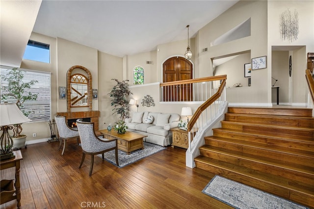 1610 Via Estrella, Pomona, CA 91768 - living room featuring high vaulted ceiling, stairs, and hardwood / wood-style flooring