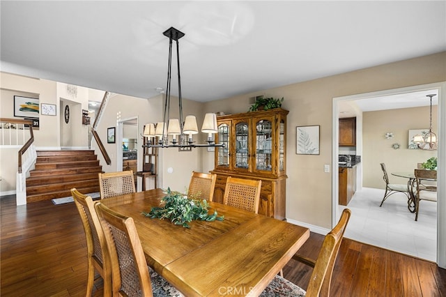 1610 Via Estrella, Pomona, CA 91768 - dining room featuring a chandelier, stairs, and hardwood / wood-style flooring