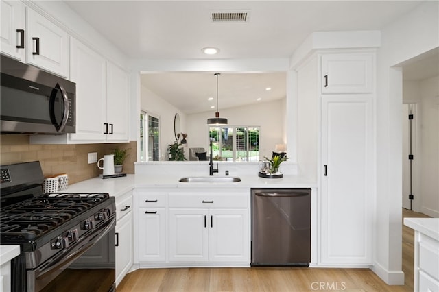 3705 Cypress Ln, Yorba Linda, CA 92886 - kitchen with stainless steel appliances, light countertops, light wood finished floors, lofted ceiling, and tasteful backsplash