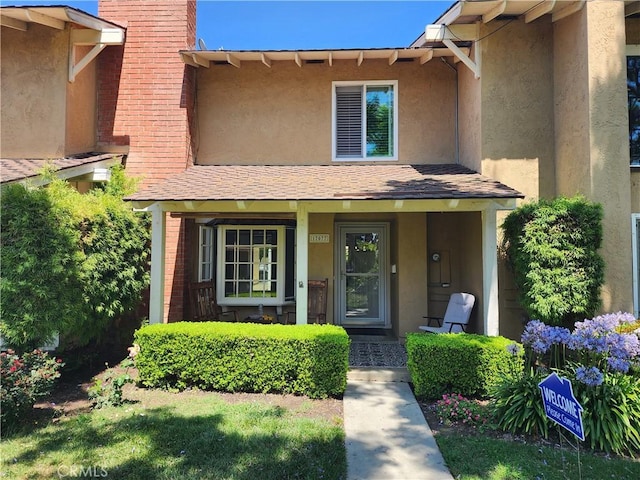 17077 Los Modelos St, Fountain Valley, CA 92708 - view of front facade featuring stucco siding, covered porch, and a chimney