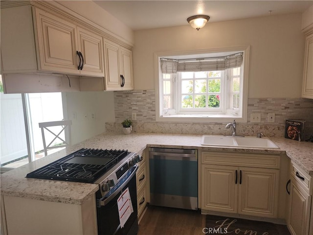 17077 Los Modelos St, Fountain Valley, CA 92708 - kitchen featuring range with gas stovetop, dishwasher, tasteful backsplash, and cream cabinetry