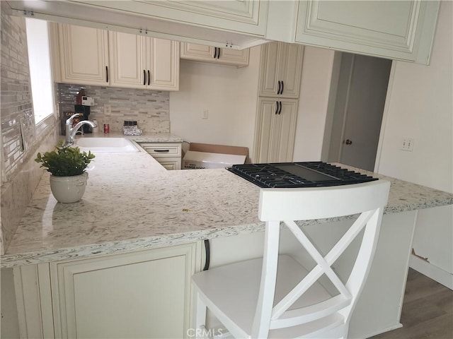 17077 Los Modelos St, Fountain Valley, CA 92708 - kitchen featuring cream cabinetry, dark wood-style flooring, light stone counters, and tasteful backsplash
