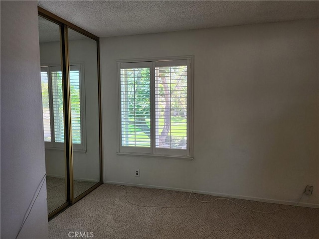 17077 Los Modelos St, Fountain Valley, CA 92708 - carpeted spare room featuring a textured ceiling and baseboards