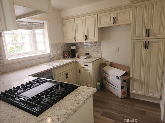 17077 Los Modelos St, Fountain Valley, CA 92708 - kitchen with cream cabinetry, stovetop, and decorative backsplash
