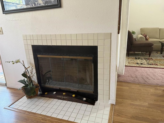 1826 Via Cuarto, Oceanside, CA 92056 - detailed view of a tile fireplace, wood finished floors, and a textured wall