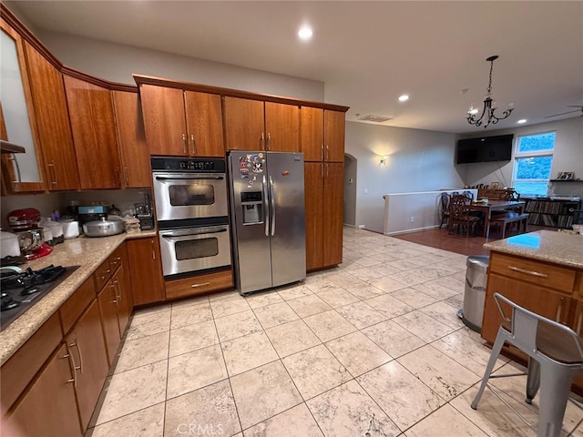 1324 Pinetree Dr, Frazier Park, CA 93225 - kitchen with appliances with stainless steel finishes, brown cabinets, a chandelier, recessed lighting, and light tile patterned floors