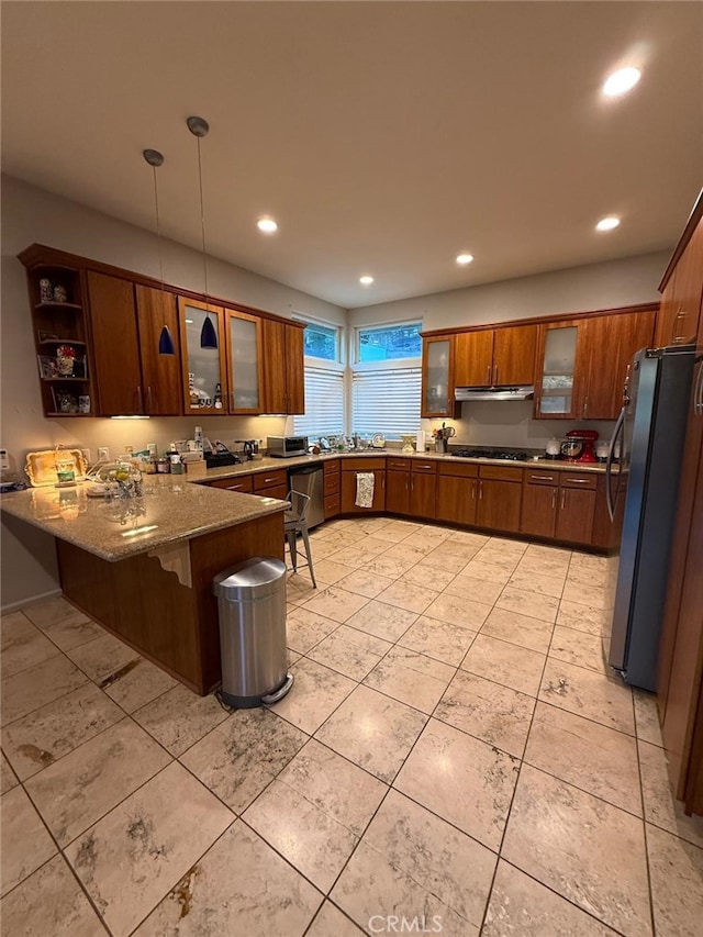 1324 Pinetree Dr, Frazier Park, CA 93225 - kitchen featuring a peninsula, appliances with stainless steel finishes, brown cabinetry, recessed lighting, and glass insert cabinets