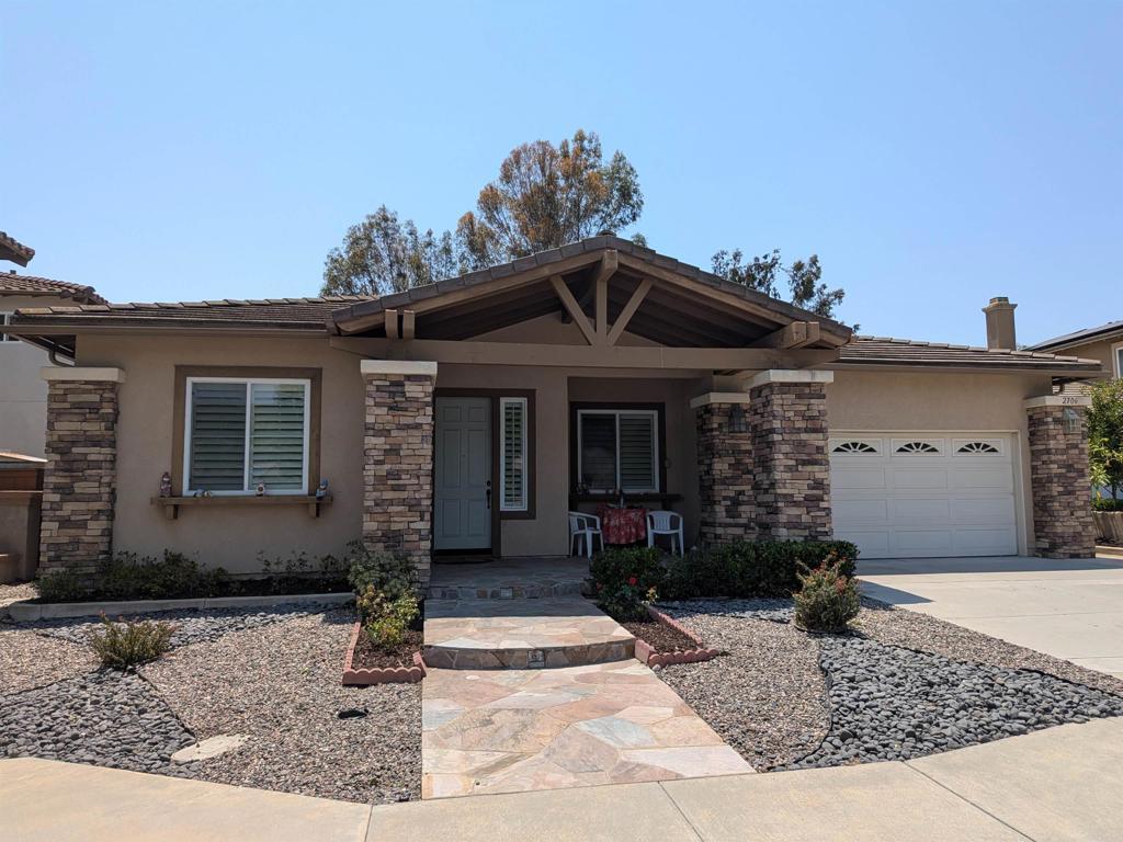 2706 Valleycreek Cir, Chula Vista, CA 91914 - view of front of house featuring stucco siding, a porch, a garage, concrete driveway, and a tile roof
