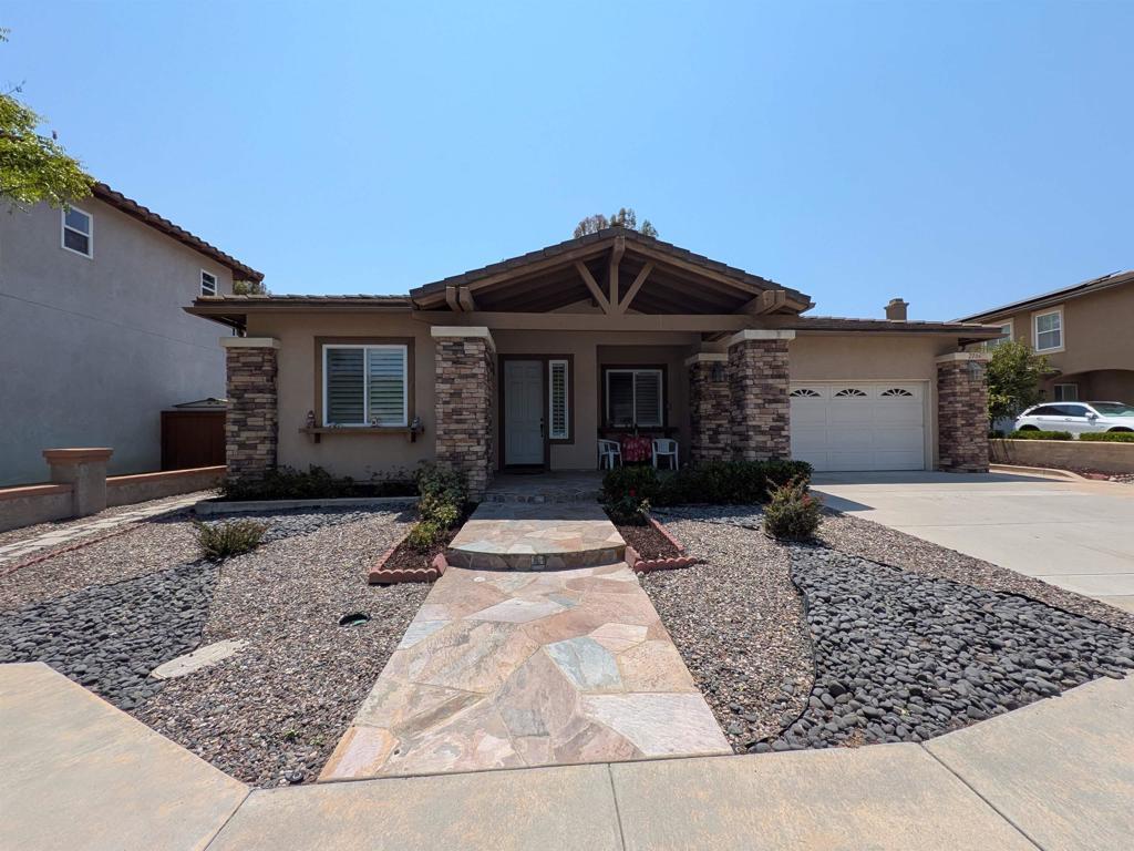 2706 Valleycreek Cir, Chula Vista, CA 91914 - view of front of home featuring stucco siding, a garage, driveway, and a porch