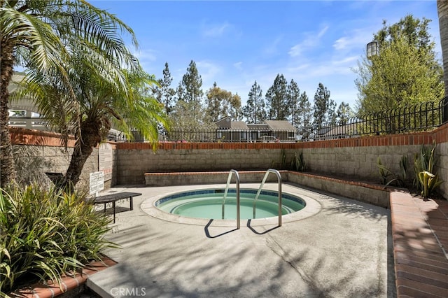 45 Bramble Ln Unit 109, Aliso Viejo, CA 92656 - view of pool with a hot tub, a fenced backyard, and a patio