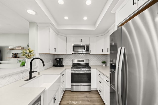 45 Bramble Ln Unit 109, Aliso Viejo, CA 92656 - kitchen with stainless steel appliances, recessed lighting, white cabinets, light countertops, and backsplash