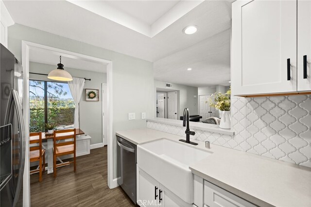 45 Bramble Ln Unit 109, Aliso Viejo, CA 92656 - kitchen featuring backsplash, fridge with ice dispenser, stainless steel dishwasher, white cabinetry, and light countertops