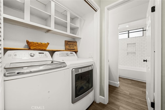 45 Bramble Ln Unit 109, Aliso Viejo, CA 92656 - washroom featuring washer and dryer and wood finished floors
