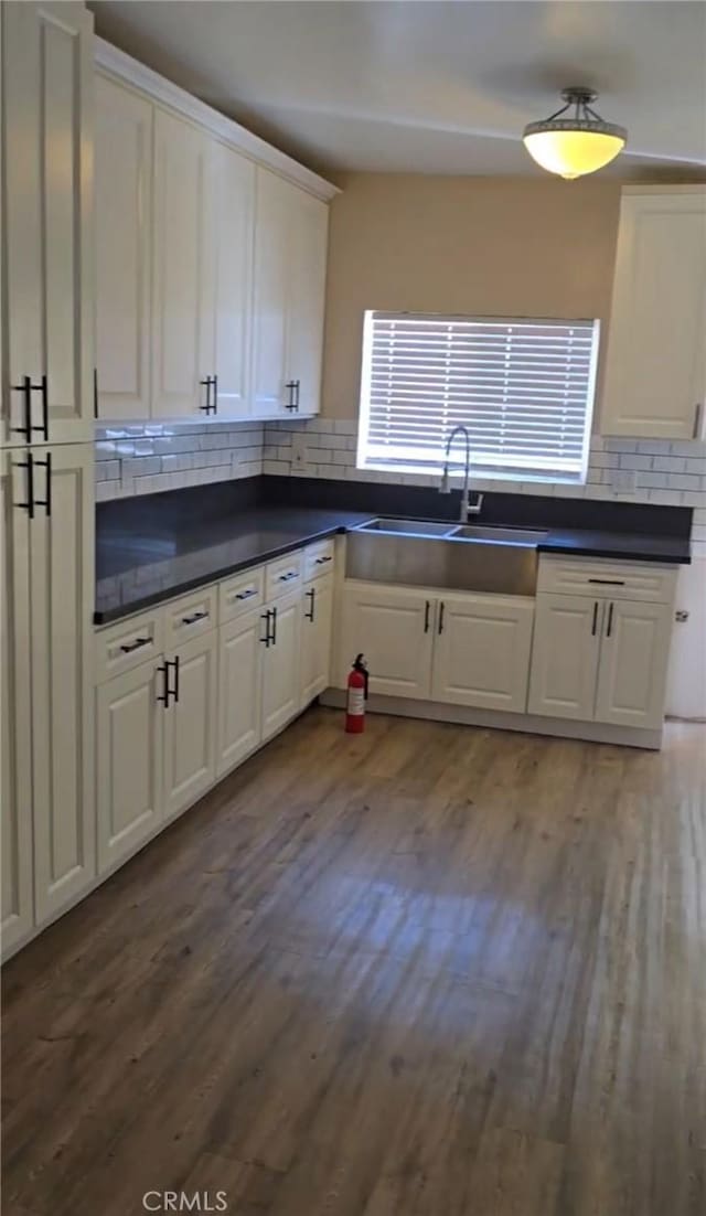 625 Xenia Ave, Beaumont, CA 92223 - kitchen featuring backsplash, dark countertops, wood finished floors, and white cabinets