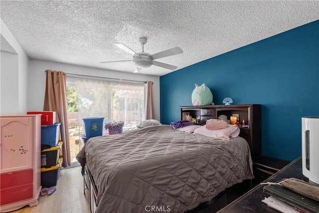 1062 Golden Rain St, Upland, CA 91786 - bedroom featuring a textured ceiling, wood finished floors, a ceiling fan, and access to exterior