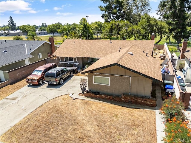 1062 Golden Rain St, Upland, CA 91786 - view of front of property featuring roof with shingles, concrete driveway, and board and batten siding