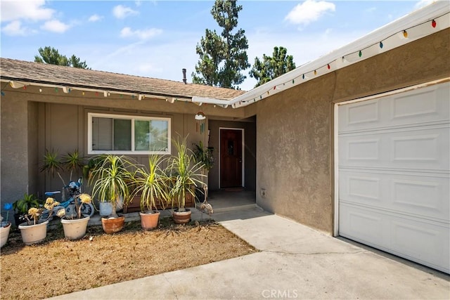 1062 Golden Rain St, Upland, CA 91786 - doorway to property with a garage, stucco siding, and a shingled roof