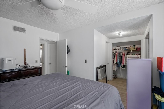 1062 Golden Rain St, Upland, CA 91786 - bedroom with a textured ceiling, wood finished floors, and ceiling fan
