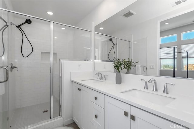 27554 Sparrow Ct, Valencia, CA 91381 - bathroom featuring a shower stall, double vanity, and recessed lighting