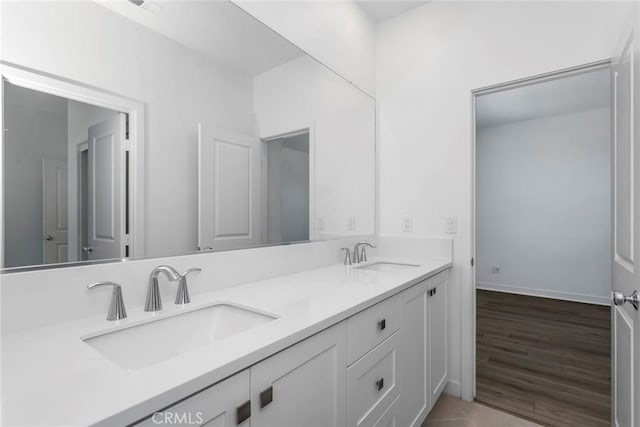 27554 Sparrow Ct, Valencia, CA 91381 - full bathroom with double vanity and wood finished floors