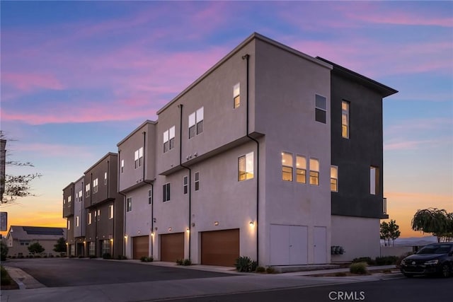 27554 Sparrow Ct, Valencia, CA 91381 - property at dusk with an attached garage and driveway