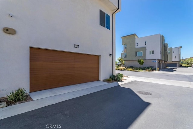 27554 Sparrow Ct, Valencia, CA 91381 - view of property exterior with stucco siding and a garage