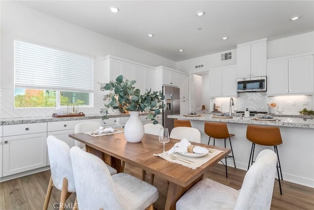 27554 Sparrow Ct, Valencia, CA 91381 - dining room featuring light wood-type flooring and recessed lighting