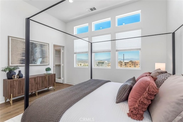 27554 Sparrow Ct, Valencia, CA 91381 - bedroom featuring a towering ceiling, wood finished floors, and recessed lighting