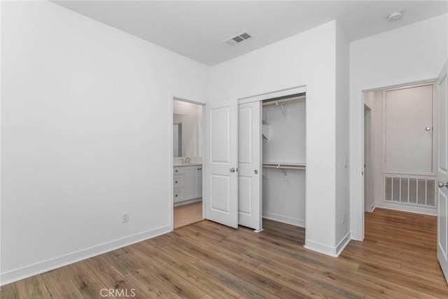27554 Sparrow Ct, Valencia, CA 91381 - unfurnished bedroom featuring wood finished floors, a closet, and ensuite bathroom