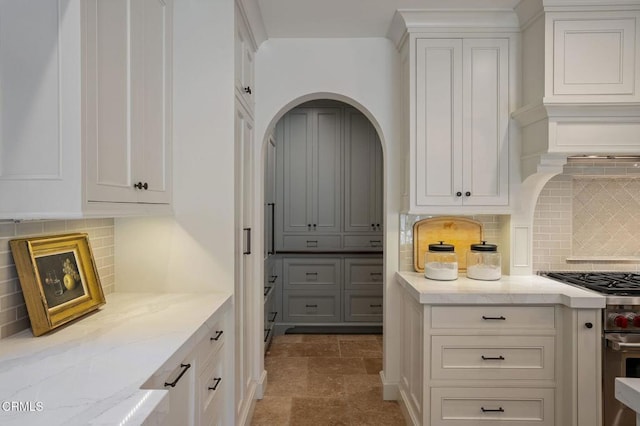 1370 Hillcrest Ave, Pasadena, CA 91106 - kitchen featuring high end stainless steel range oven, light stone countertops, tasteful backsplash, and white cabinets