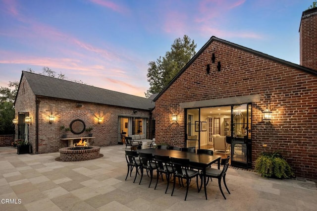1370 Hillcrest Ave, Pasadena, CA 91106 - patio terrace at dusk with a fire pit, a patio, and outdoor dining area
