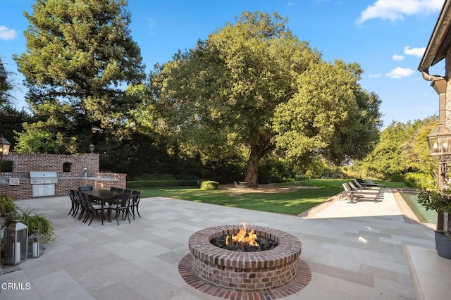 1370 Hillcrest Ave, Pasadena, CA 91106 - view of patio featuring area for grilling, an outdoor fire pit, view of scattered trees, and outdoor dining space