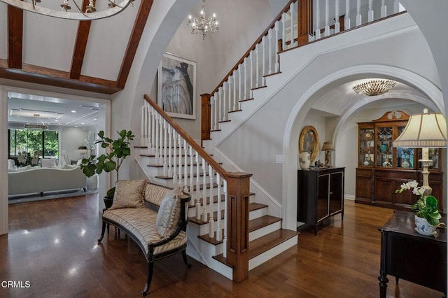 1370 Hillcrest Ave, Pasadena, CA 91106 - staircase featuring a towering ceiling, wood finished floors, a chandelier, and arched walkways