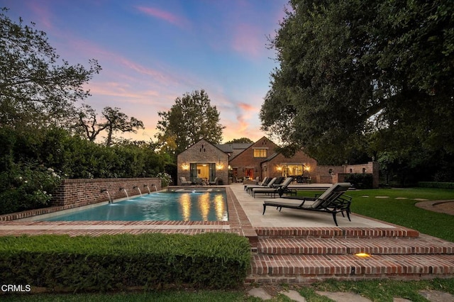 1370 Hillcrest Ave, Pasadena, CA 91106 - pool at dusk featuring a patio, an outdoor pool, and a lawn