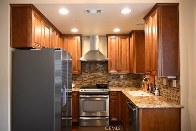 31 Alta St Unit A, Arcadia, CA 91006 - kitchen featuring appliances with stainless steel finishes, wall chimney range hood, light stone countertops, tasteful backsplash, and brown cabinetry