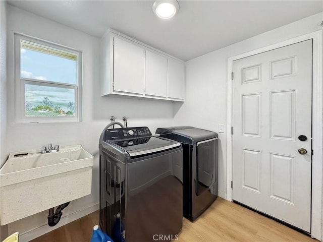 1472 N San Antonio Ave, Upland, CA 91786 - washroom featuring washer and dryer, light wood-style floors, and cabinet space