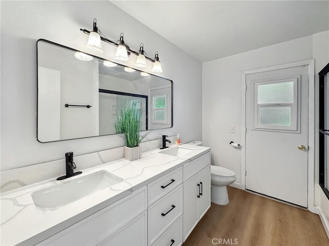 1472 N San Antonio Ave, Upland, CA 91786 - full bathroom with double vanity, a shower with door, and wood finished floors