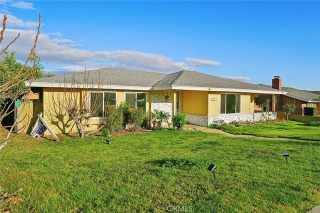 1472 N San Antonio Ave, Upland, CA 91786 - back of property with stone siding, a lawn, a chimney, and roof with shingles