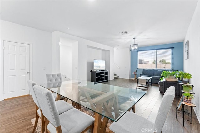 14053 Spurlock Ln Unit 3, Gardena, CA 90247 - dining room featuring wood finished floors and a chandelier