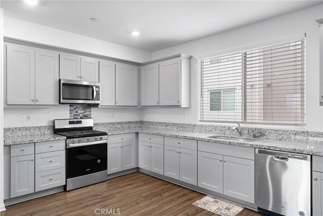 14053 Spurlock Ln Unit 3, Gardena, CA 90247 - kitchen with appliances with stainless steel finishes, dark wood-style floors, light stone countertops, recessed lighting, and gray cabinets