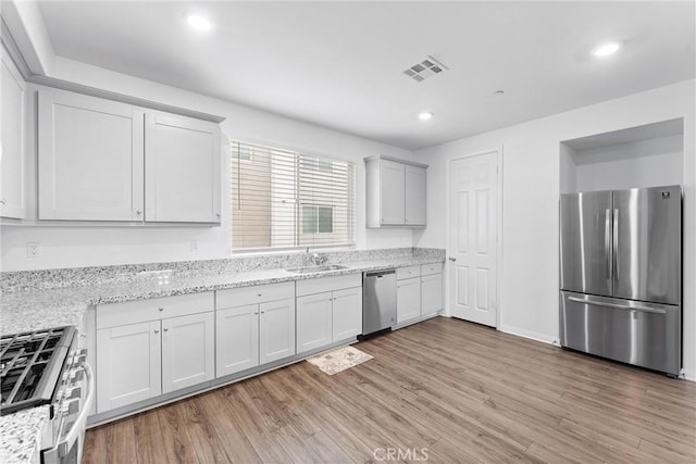 14053 Spurlock Ln Unit 3, Gardena, CA 90247 - kitchen with stainless steel appliances, light wood finished floors, recessed lighting, and light stone counters
