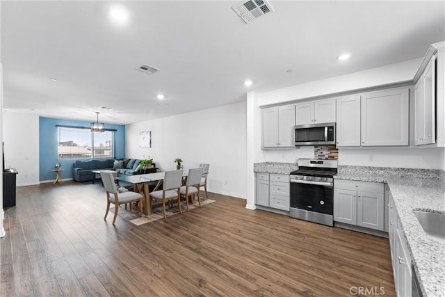 14053 Spurlock Ln Unit 3, Gardena, CA 90247 - kitchen featuring appliances with stainless steel finishes, dark wood-style floors, open floor plan, recessed lighting, and a chandelier