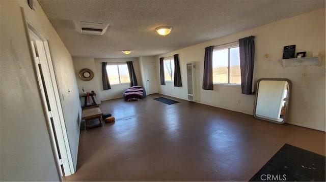1729 N Deer Trl, Landers, CA 92285 - interior space featuring concrete flooring and a textured ceiling