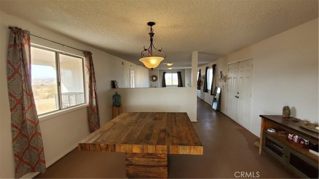 1729 N Deer Trl, Landers, CA 92285 - unfurnished dining area featuring a textured ceiling and concrete flooring