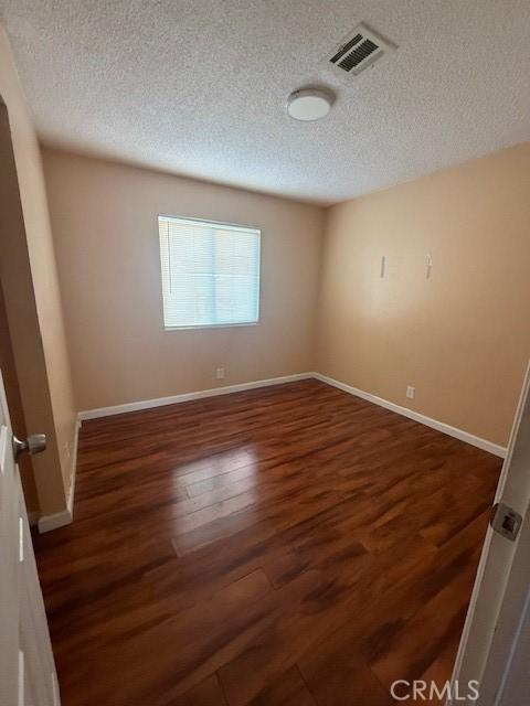 444 Corcoran Ave Unit 4, Vallejo, CA 93536 - spare room with a textured ceiling and wood finished floors