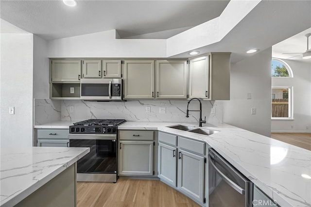 1534 Princeton Ave, Madera, CA 93637 - kitchen with stainless steel appliances, light wood-style floors, light stone counters, decorative backsplash, and ceiling fan