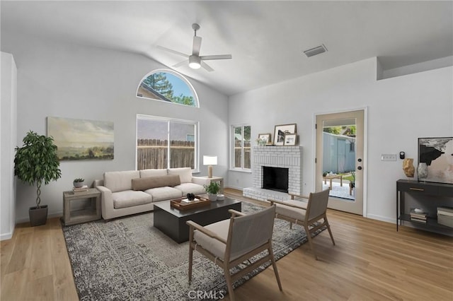 1534 Princeton Ave, Madera, CA 93637 - living area with a ceiling fan, vaulted ceiling, a fireplace, and light wood finished floors